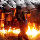  A demonstrator reacts when Molotov cocktails hit the ground in front of security forces during protests against election results after Venezuela's President Nicolas Maduro and his opposition rival Edmundo Gonzalez claimed victory in Sunday's presidential election, in Puerto La Cruz, Venezuela. REUTERS/Samir Aponte 