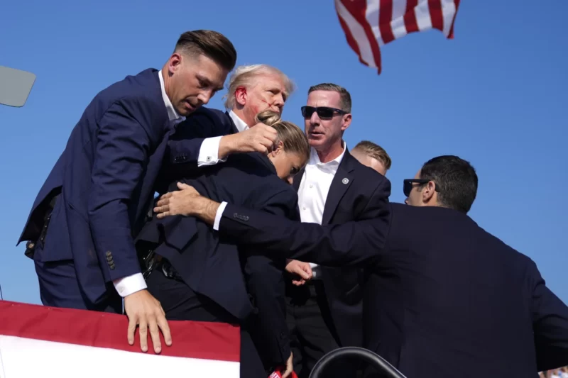 Republican presidential candidate former President Donald Trump is surrounded by U.S. Secret Service agents at a campaign rally, Saturday, July 13, 2024, in Butler, Pa. (AP Photo/Evan Vucci)