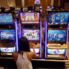 A casino trainee demonstrates how to play a slot machine in the Philippines, April 16, 2015. REUTERS/Erik De Castro/File Photo 