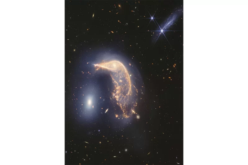The neighboring galaxies, nicknamed Penguin and the Egg, have been tangled up for tens of millions of years, according to NASA. APnews