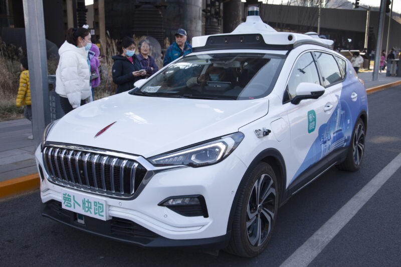 Beijing residents use the robotaxi service provided by the technology giant Baidu Inc. (Photo by Jiao Hongtao /for China Daily)